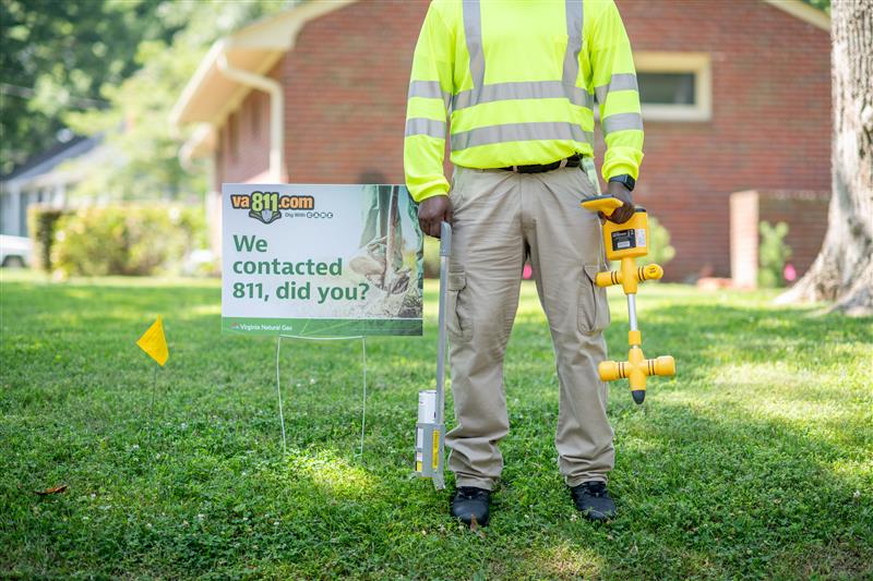 man standing in a yard preparing to dig