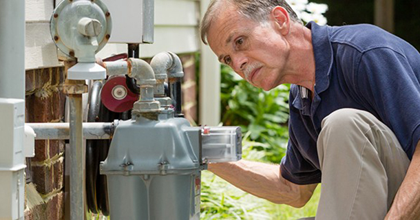 man inspecting a meter