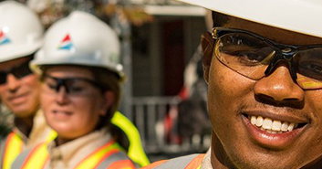 man standing with work helmet