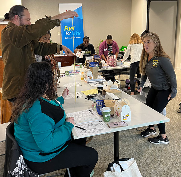 volunteers standing near prepared bookbags