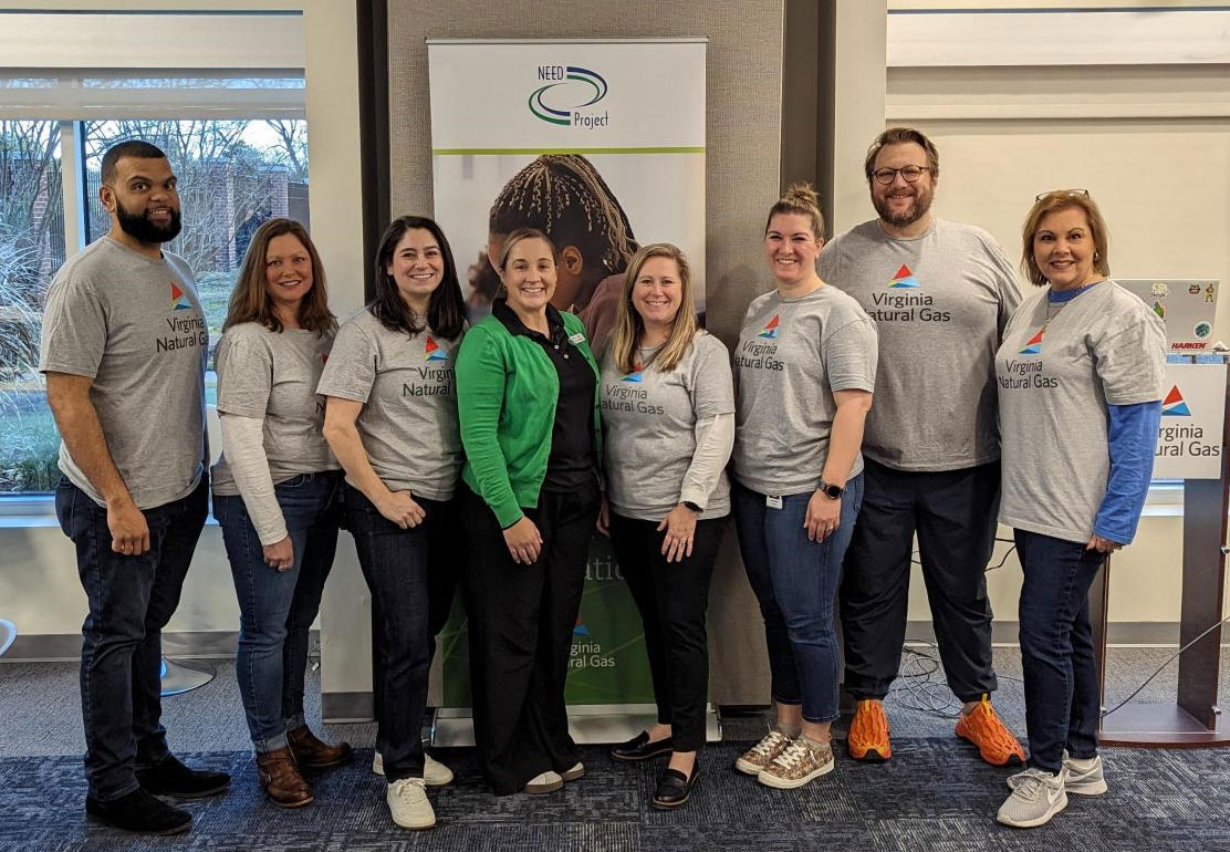 volunteers standing near prepared bookbags